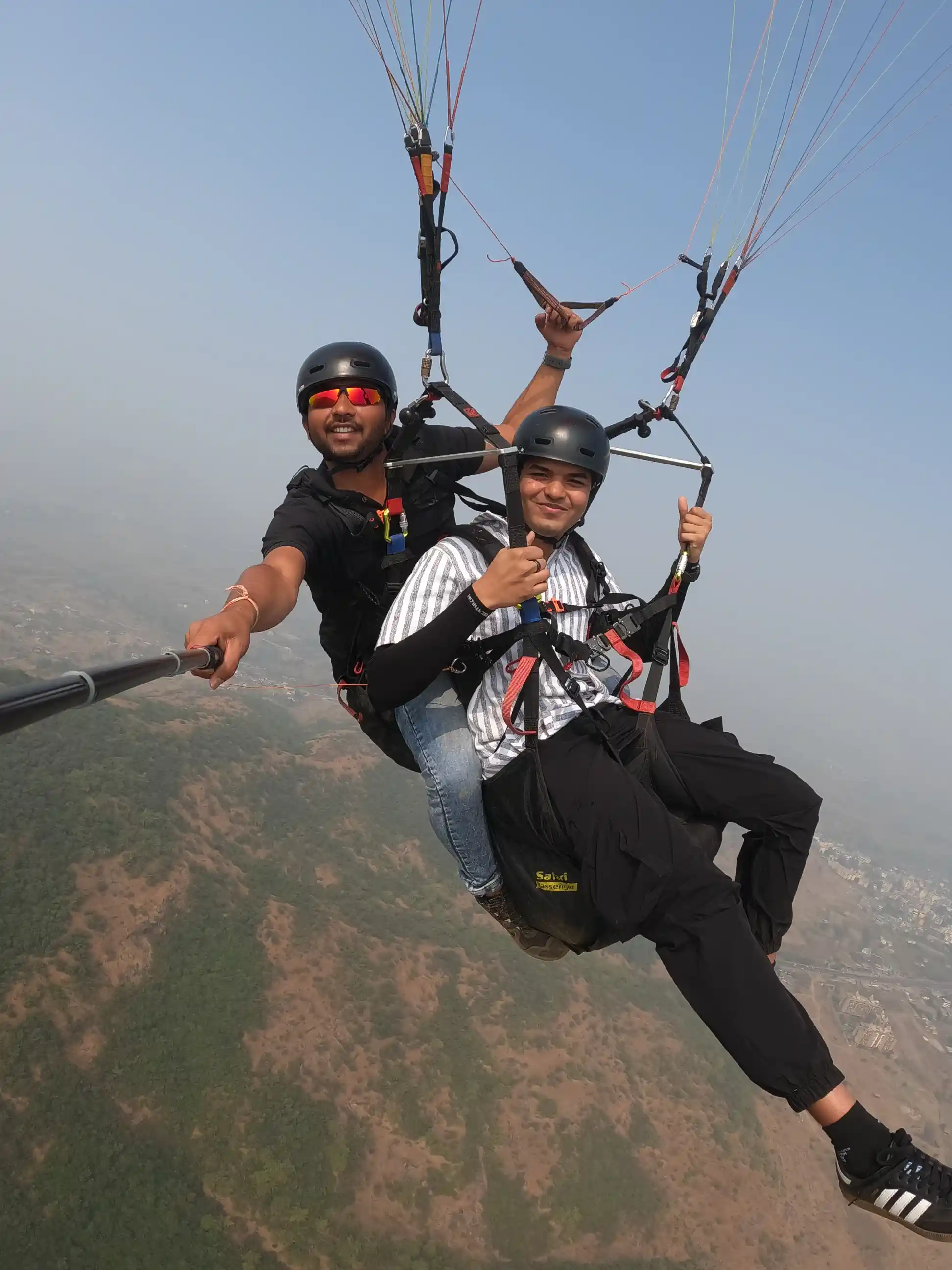 Tandem paragliding flight over Kamshet hills during sunset