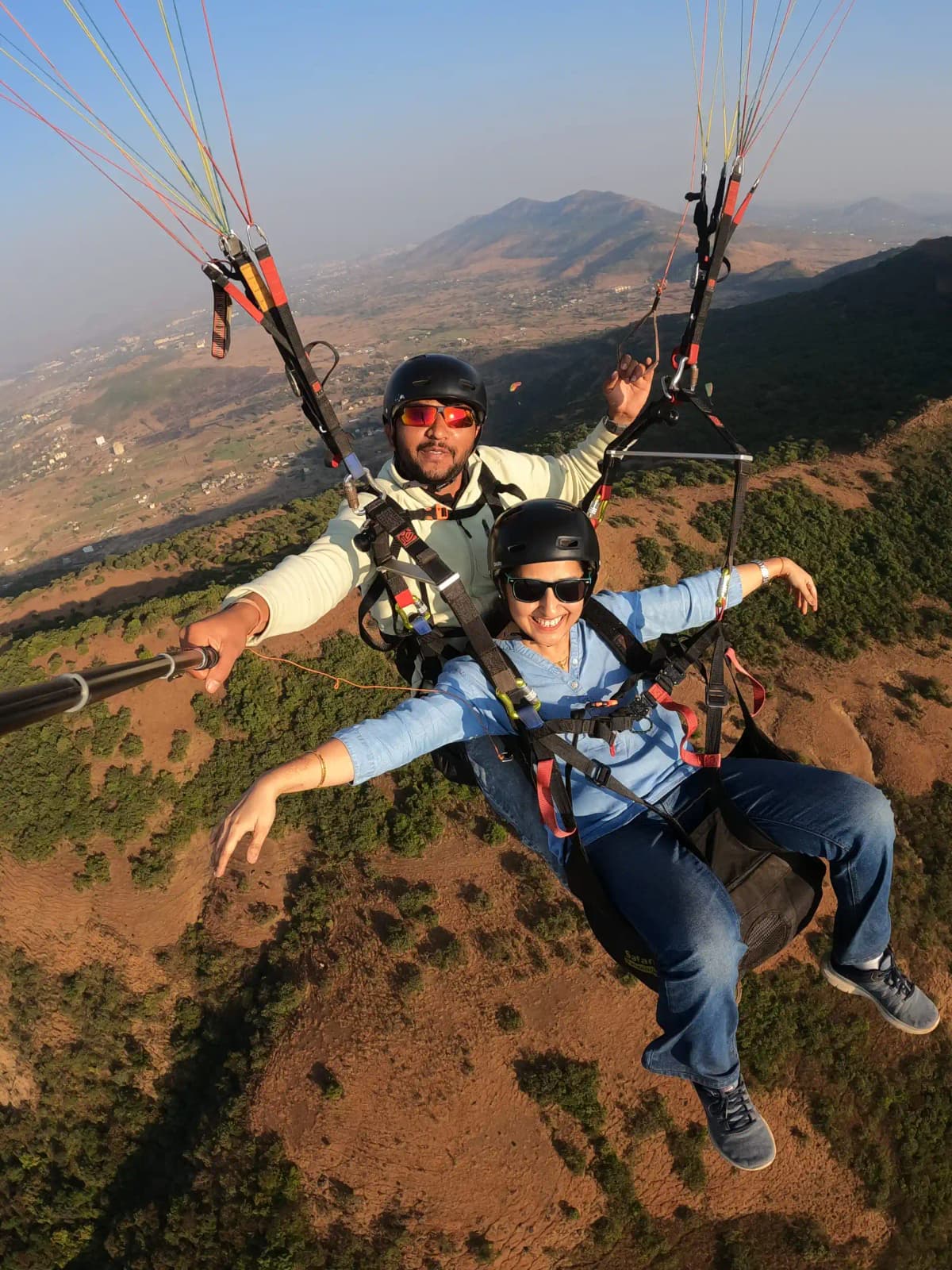 Blue sky and white paraglider wing soaring high