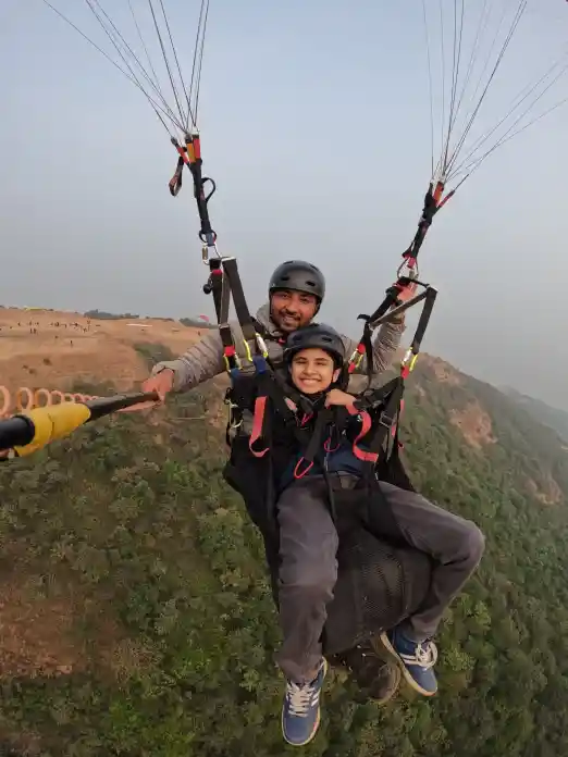 Professional paragliding instructor with a student